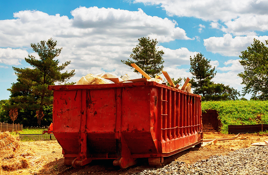Dumpsters being full with garbage in a city.